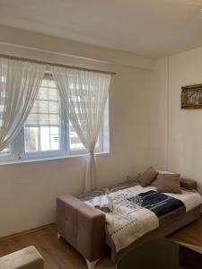 a bedroom with a bed and a window at Old Town Sidro Apartment in Sarajevo