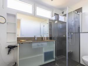 a bathroom with a glass shower and a sink at Holiday Home Les Genêts by Interhome in Nice