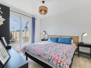 a bedroom with a bed and a large window at Holiday Home Maison Edgar Luce by Interhome in Agon Coutainville