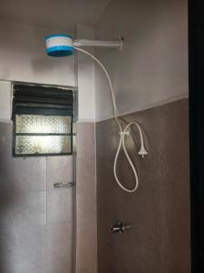 a shower with a shower head in a bathroom at Klen CBD apartments in Kisumu