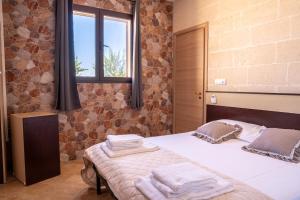 a bedroom with a bed with towels on it at Tenuta delle Marene - Only Adults in Torricella