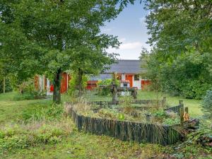 a garden in front of a red house at Holiday Home Elea - 450m to the fjord by Interhome in Skalstrup