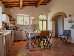 a kitchen with a table and chairs in a room at Holiday Home Villa Albertine by Interhome in Fattoria Spedaletto