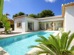 a swimming pool in front of a villa at Villa Serenidad by Interhome in Casas de Torrat