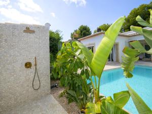 a bathroom with a shower next to a pool at Villa Serenidad by Interhome in Casas de Torrat