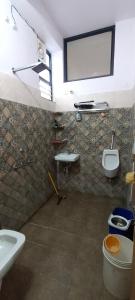 a bathroom with two sinks and a toilet and a window at Rajawat house in Tonk City