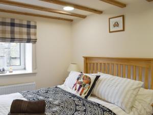 a bedroom with a bed and a window at Easter Cottage in Bamford +12 photos