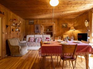 a dining room with a table and chairs and a couch at Apartment Pozzaglio Mountain Home by Interhome in Valdisotto +45 photos