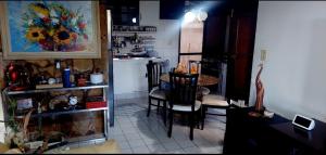 a living room with a table and chairs and a kitchen at Cond CHACARA BAVIERA in Gravatá