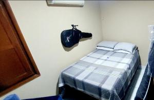 a room with a bed and a bag hanging on a wall at Cond CHACARA BAVIERA in Gravatá +50 photos