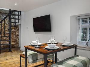 a dining room with a wooden table with wine glasses at Ye Olde Mottram Chip Shop in Glossop