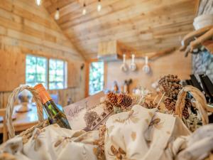 a picnic basket with a bottle of wine and pine cones at The Retreat - Uk50421 in Bisterne