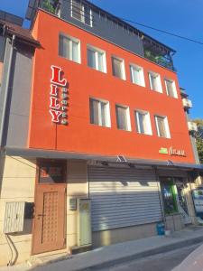 un bâtiment orange avec un panneau sur son côté dans l'établissement Lily Aparts, à Varna