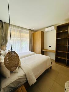 Ένα ή περισσότερα κρεβάτια σε δωμάτιο στο Villa Lily Bay Selong Belanak