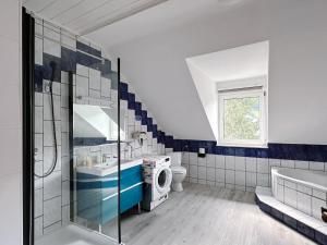 a bathroom with a shower and a sink and a washing machine at Up Residences S in Baden +40 photos