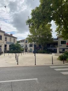 a parking lot with a row of poles on the street at Escale Détente Genas proche Eurexpo in Genas