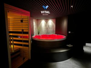 a bathroom with a red tub in a room at Boutique & Wellness Hotel Vital in Moravske Toplice