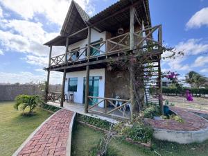 Taman di luar Chales Alegria e Estrela, Chaleville Maramar - Conforto, segurança e internet pertinho do mar