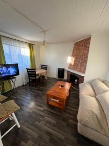 a living room with a couch and a fireplace at Casa Punta Arenas ubicación central in Punta Arenas