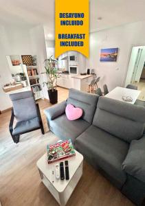 a living room with a couch and a table at Apartalux Sevilla Camas in Camas