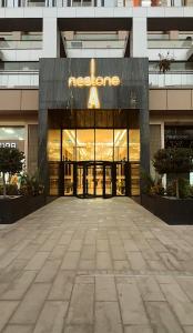 a building with a sign on the front of it at Nest One Luxury Apt View of the Entire City from the Top in Tashkent