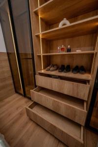 a set of stairs in a room with shoes on them at Apartman White Pearl in Palić