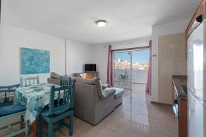a living room with a couch and a table at Las Floritas in Playa de las Americas