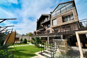 a large house with a spiral staircase in a yard at Escapes Boutique Hotel & Restaurant in Dilijan