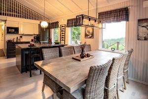 a kitchen and dining room with a wooden table and chairs at Trysilfjellet Nord 267 in Trysil