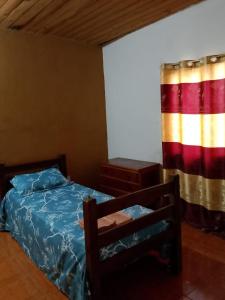 a bedroom with a bed and a window at Casa Adelaida in Puerto Iguazú
