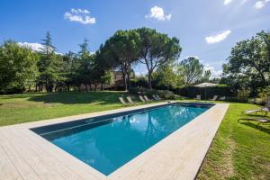 a swimming pool in the yard of a house at Fattoria Belvedere alle Vigne VacaVilla Exclusive in Sinalunga +34 photos