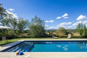 a swimming pool in a yard with a view at Fattoria Belvedere alle Vigne VacaVilla Exclusive in Sinalunga
