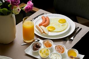 a plate of breakfast food with eggs and toast on a table at Escapes Boutique Hotel & Restaurant in Dilijan