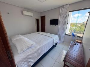 Katil atau katil-katil dalam bilik di Chales Alegria e Estrela, Chaleville Maramar - Conforto, segurança e internet pertinho do mar