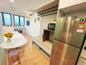 a kitchen with a small table and a refrigerator at KL Sentral Monorail 4 pax Kuala Lumpur, Sky Pool Family Merdeka 118 Nice View in Kuala Lumpur