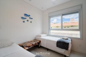 a bedroom with a bed and a window at Apt w/ balcony and grill 220m from the Sea ALB0201 in Florianópolis +19 photos
