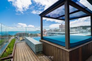 a balcony with a swimming pool on top of a building at Apt w/ balcony and grill 220m from the Sea ALB0201 in Florianópolis