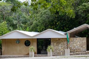 a building with a flag in front of it at Chan-Kah Resort Village in Palenque