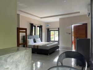 a bedroom with a bed and a table and chairs at Baan klang suan at kantiang bay in Ko Lanta