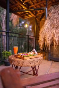 a table with a plate of food and a drink on it at Cliff Edge Villa in Ella +58 photos
