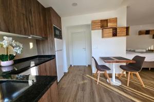 a kitchen with a table and two chairs in a kitchen at Marinha Grande Apartamentos Rainbow N9 in Marinha Grande