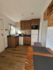 a kitchen with wooden cabinets and a white refrigerator at Marinha Grande Apartamentos Rainbow N9 in Marinha Grande +24 photos
