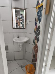 ein Badezimmer mit Waschbecken und Spiegel in der Unterkunft Canto da paz in Praia Grande