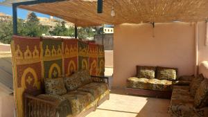 a living room with a couch and a table at dar ben issa in Fez