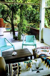 a patio with two chairs and a table and a couch at Authentic 2BR Villa in Koh Phangan in Ko Ma