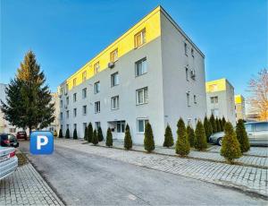 a large building on a street with a parking lot at Relax Apartment 2 in Sighişoara