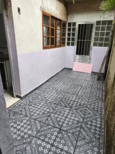 a house with a tile floor in front of a door at Canto da paz in Praia Grande