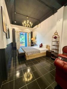 a bedroom with a bed and a chandelier at Skylux Hanoi Homestay in Hanoi