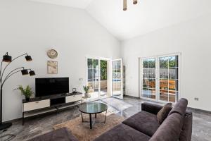 a living room with a couch and a tv at Villa Nina with private pool and BBQ near Poreč in Bonaci