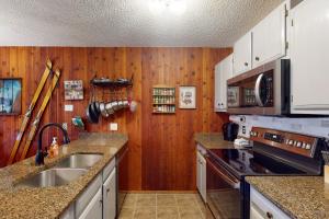 a kitchen with a sink and a stove top oven at Silverado II 421 in Winter Park